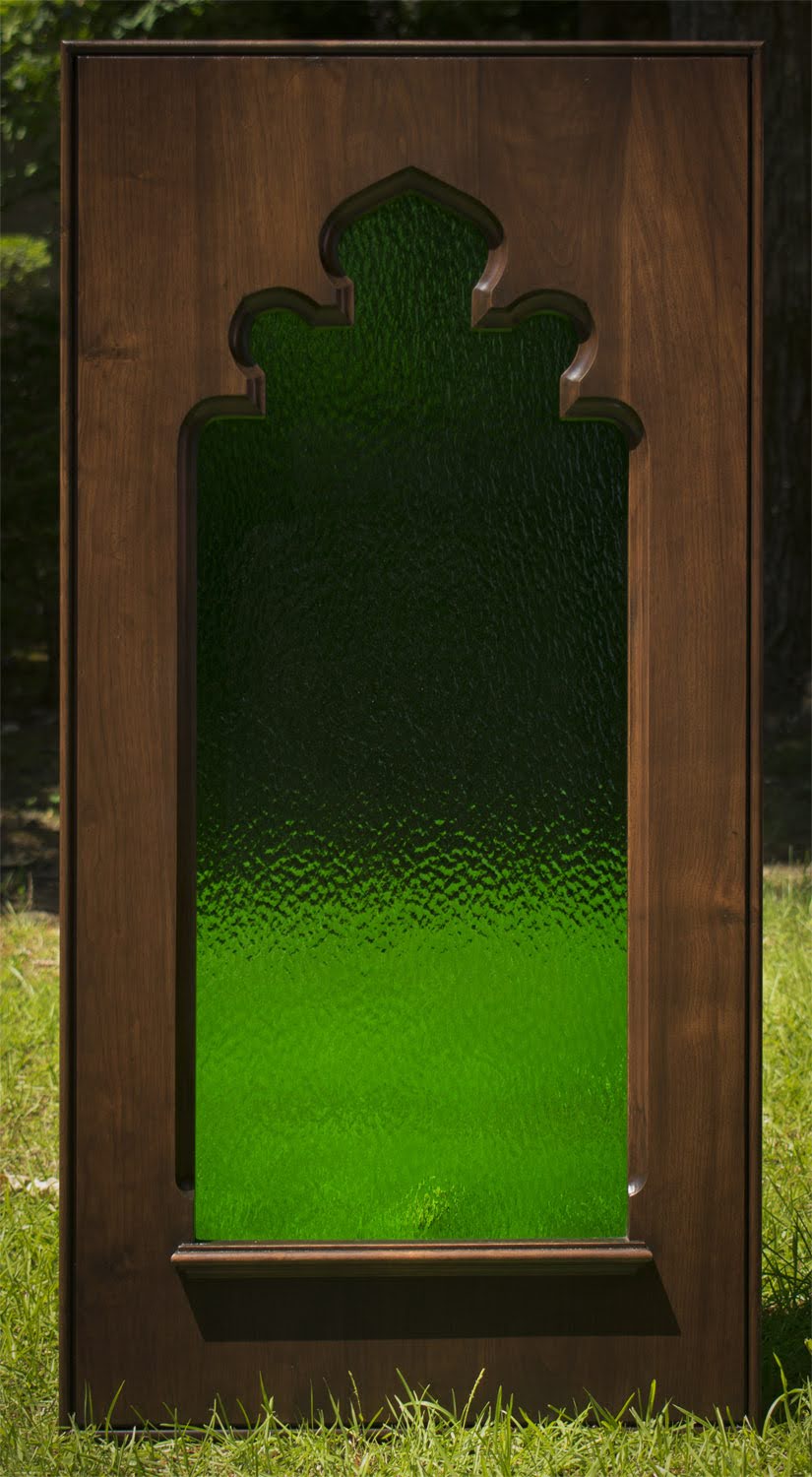 Carved gothic window with green stained glass