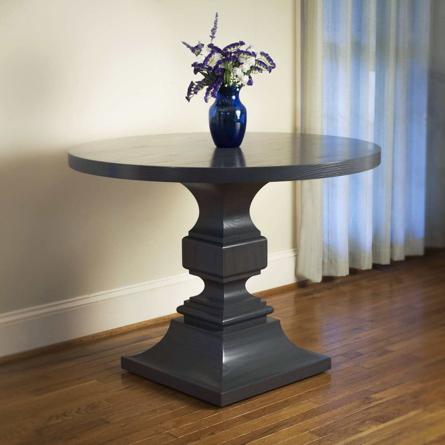 Round table with square turned base